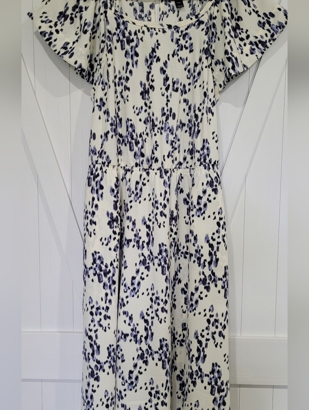 Beautiful summer dress in white with a black and blue pattern.